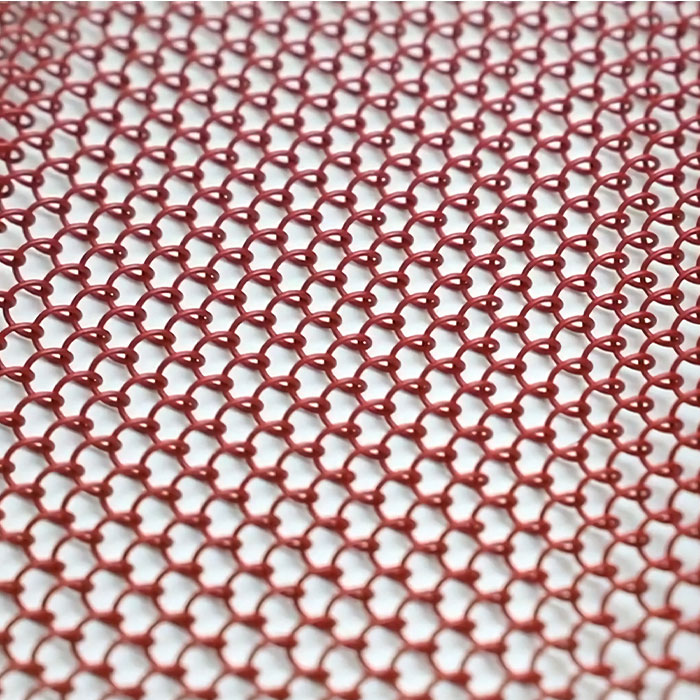A piece of unfolded red metal coil drapery