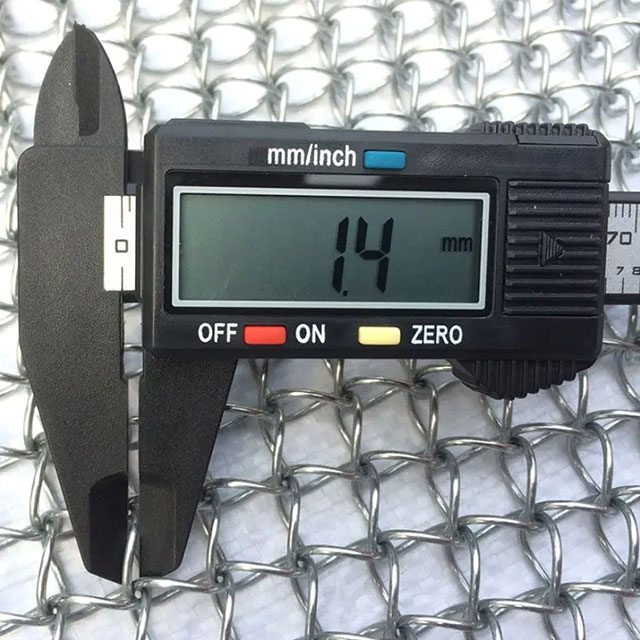 A caliper is used to test the wire diameter of honeycomb architectural mesh